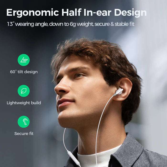 White half in-ear wired earphones worn with cable visible along the side of head