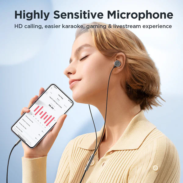 White wired in-ear earbuds worn in ear with inline microphone on cable